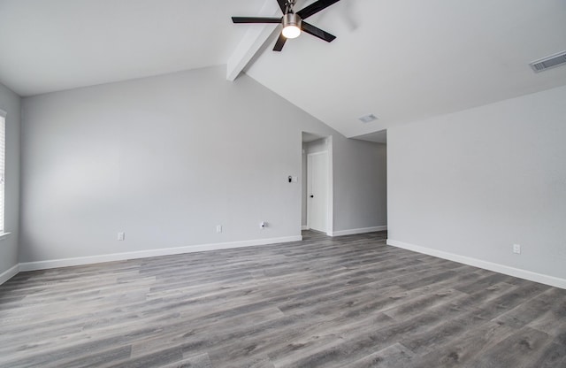 unfurnished room with visible vents, baseboards, ceiling fan, and vaulted ceiling with beams