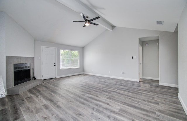 unfurnished living room featuring visible vents, wood finished floors, baseboards, ceiling fan, and lofted ceiling with beams