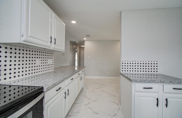 kitchen featuring light stone counters, recessed lighting, white cabinetry, and marble finish floor