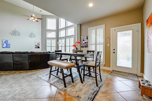 dining room featuring baseboards, ceiling fan, and light tile patterned floors