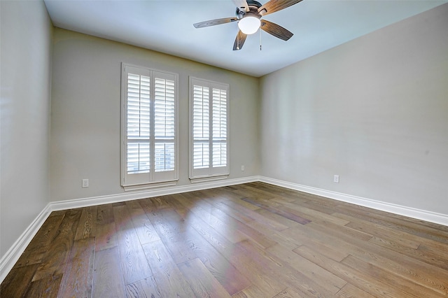 spare room featuring baseboards, ceiling fan, and wood finished floors