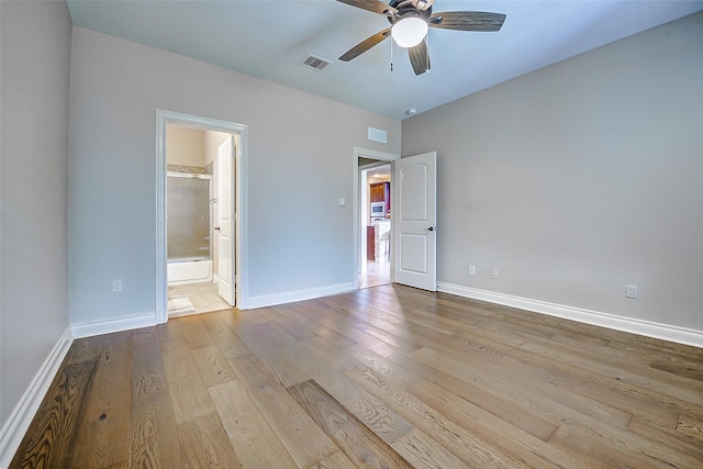 unfurnished bedroom featuring visible vents, baseboards, and wood finished floors