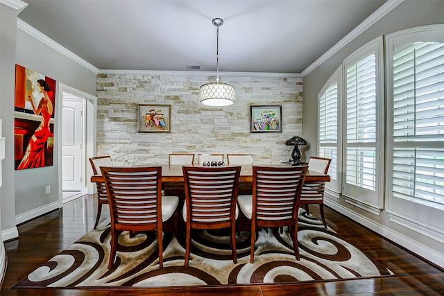 dining room featuring crown molding, baseboards, visible vents, and dark wood-style floors
