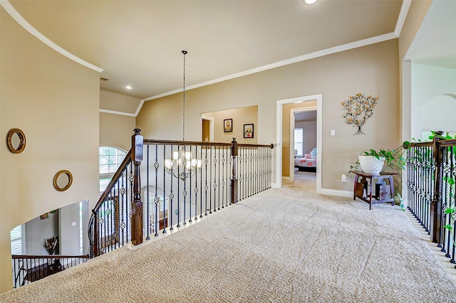 hall featuring crown molding, baseboards, plenty of natural light, and carpet flooring