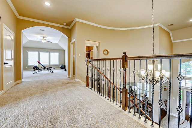 hallway with crown molding, baseboards, recessed lighting, and arched walkways