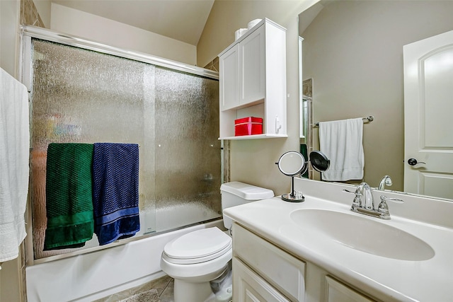 full bathroom featuring vanity, enclosed tub / shower combo, tile patterned flooring, and toilet