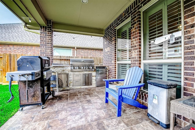 view of patio / terrace with fence, a grill, and area for grilling