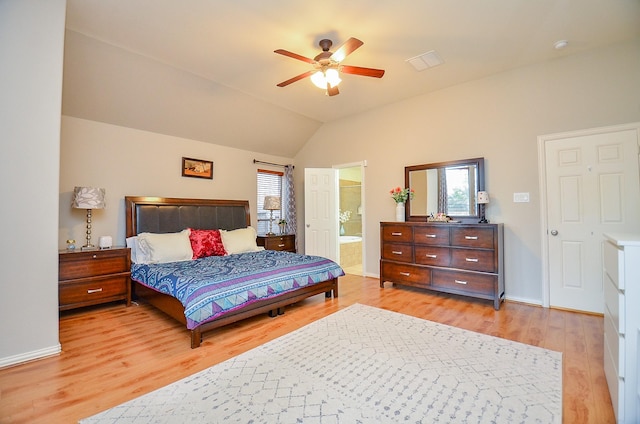 bedroom featuring multiple windows, lofted ceiling, and light wood-type flooring