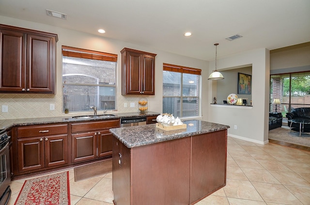 kitchen with stainless steel dishwasher, light tile patterned flooring, visible vents, and a sink