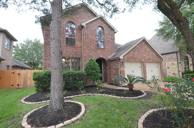 5018 Tramonte Trl, Katy, TX 77494 - traditional home with driveway, brick siding, fence, a front lawn, and an attached garage