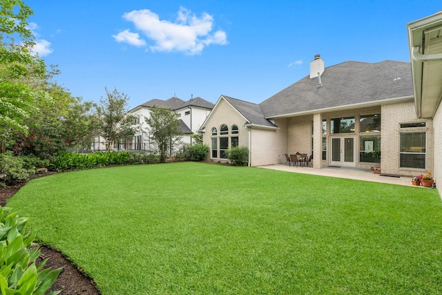 view of yard featuring french doors and a patio area