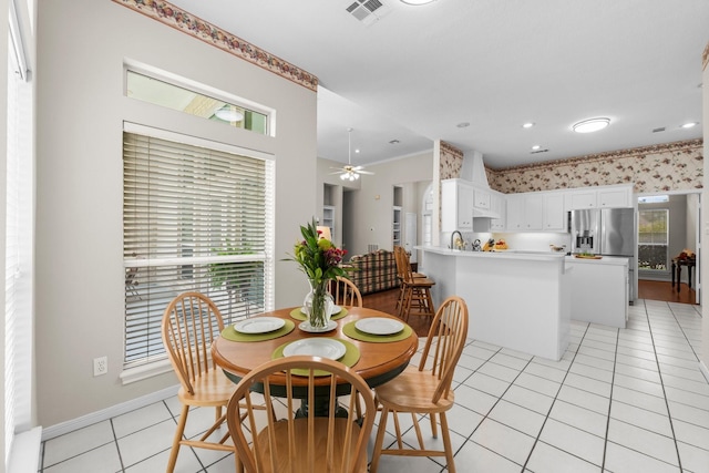 dining space featuring visible vents, baseboards, ceiling fan, and light tile patterned floors