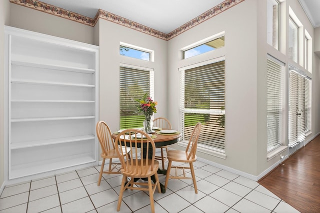 dining room with baseboards and light tile patterned floors