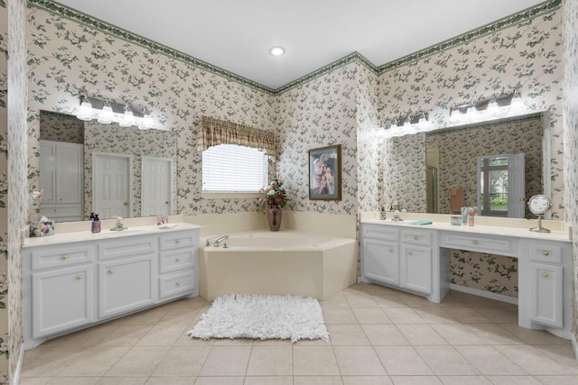 bathroom featuring a garden tub, a sink, tile patterned floors, and wallpapered walls