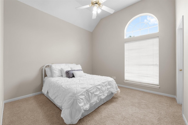 carpeted bedroom with baseboards, ceiling fan, and vaulted ceiling