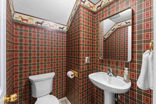 bathroom with toilet and a sink