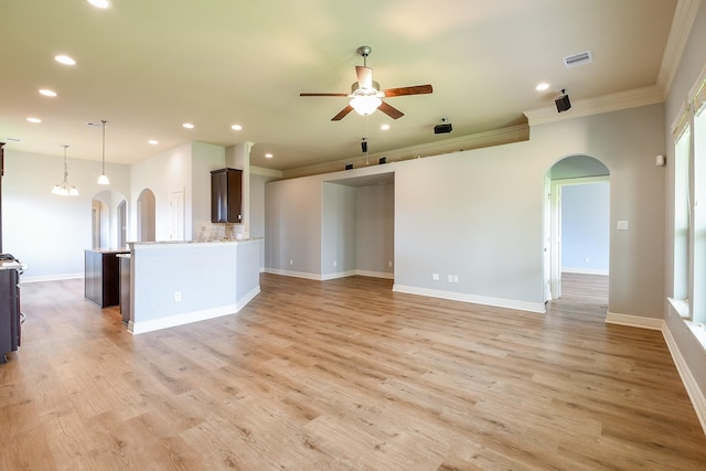 unfurnished living room with visible vents, a ceiling fan, ornamental molding, recessed lighting, and arched walkways