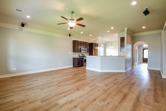 unfurnished living room featuring arched walkways, a ceiling fan, recessed lighting, visible vents, and ornamental molding