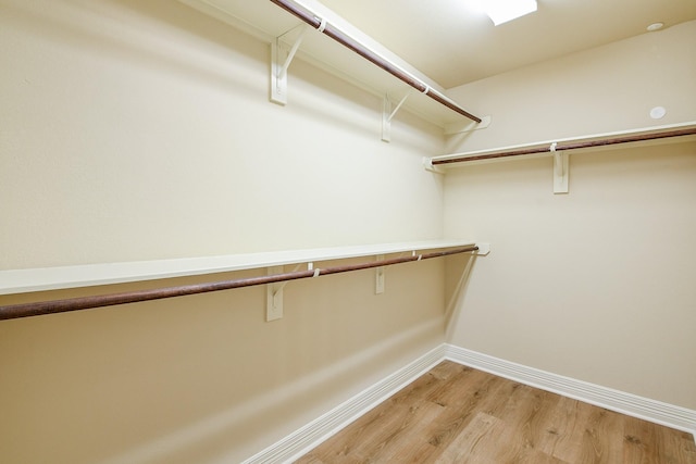 spacious closet with light wood finished floors