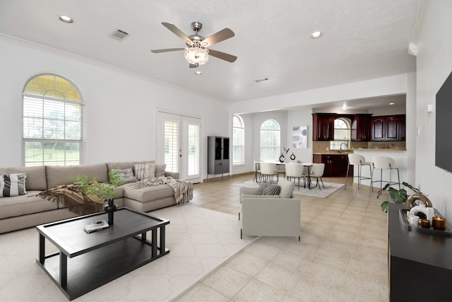 1321 E Archer Rd, Baytown, TX 77521 - living room featuring crown molding, a ceiling fan, recessed lighting, and visible vents