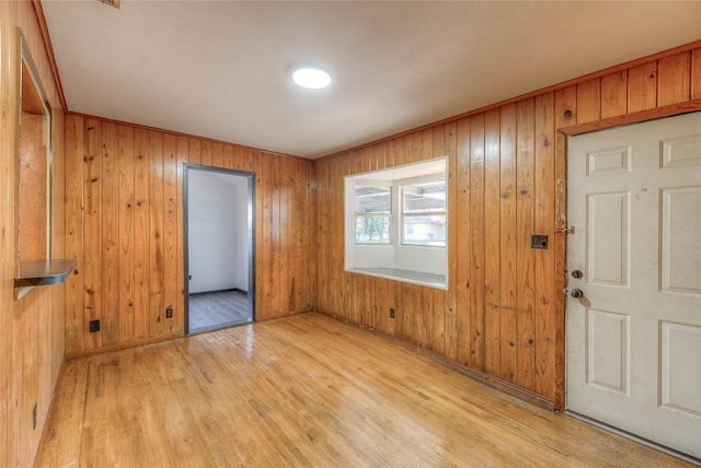 entrance foyer featuring wooden walls and light wood-style flooring