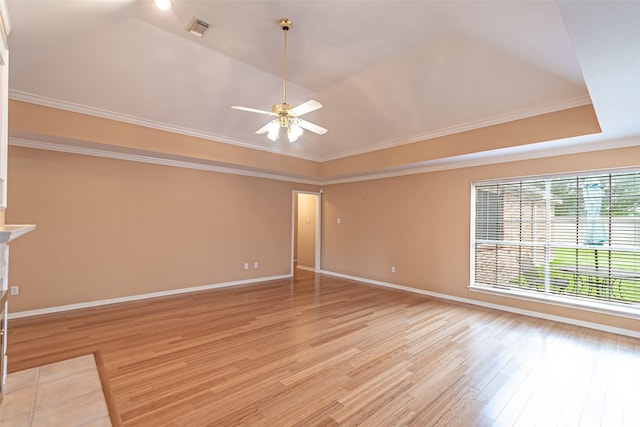 unfurnished room featuring visible vents, crown molding, ceiling fan, a tray ceiling, and light wood finished floors