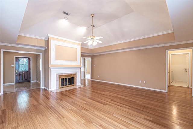 unfurnished living room with visible vents, baseboards, ceiling fan, a tiled fireplace, and light wood-style flooring