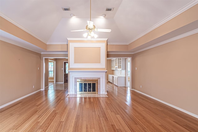 unfurnished living room with a fireplace with flush hearth, light wood-style floors, a ceiling fan, and visible vents