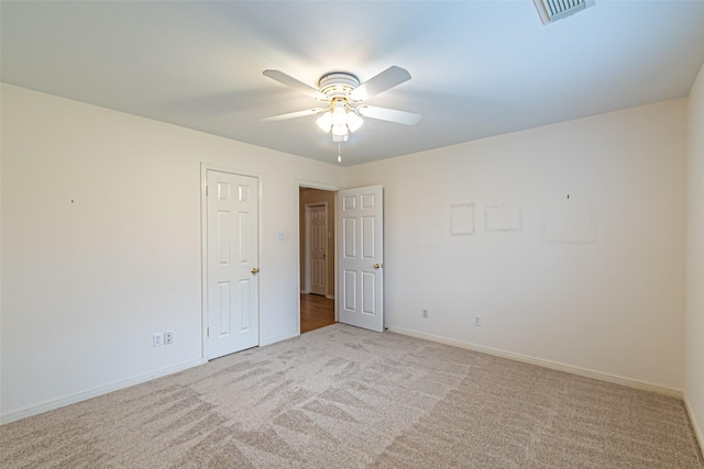 spare room featuring visible vents, baseboards, ceiling fan, and carpet floors