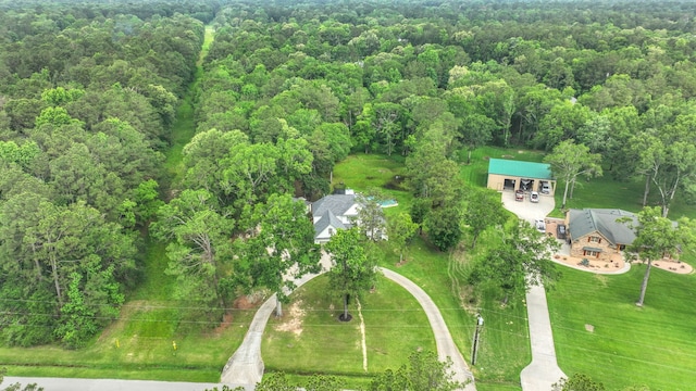birds eye view of property with a view of trees