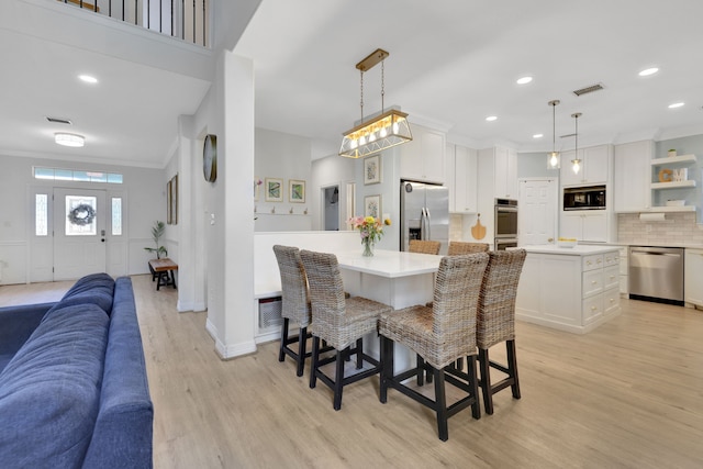 dining room featuring recessed lighting, visible vents, ornamental molding, and light wood finished floors