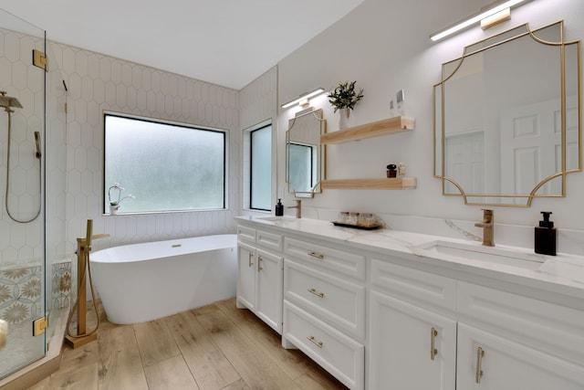 bathroom featuring a shower stall, a sink, and wood finished floors