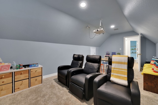 home theater room featuring baseboards, light carpet, and lofted ceiling