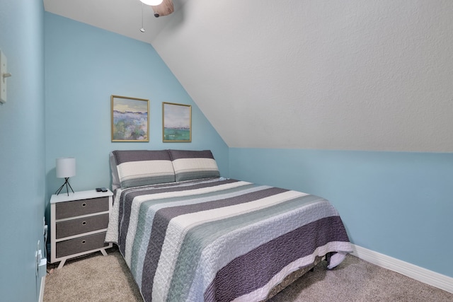 bedroom featuring carpet floors, baseboards, ceiling fan, and lofted ceiling