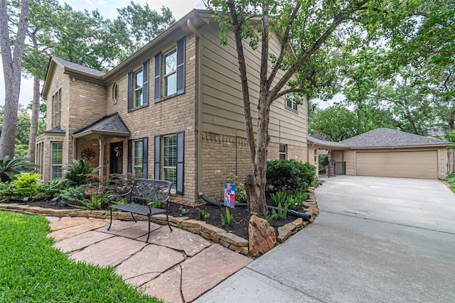 view of front of home with brick siding, driveway, and a garage