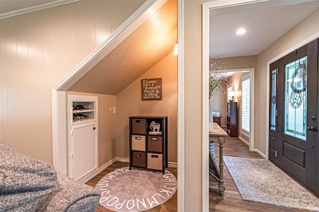 entrance foyer featuring baseboards and wood finished floors