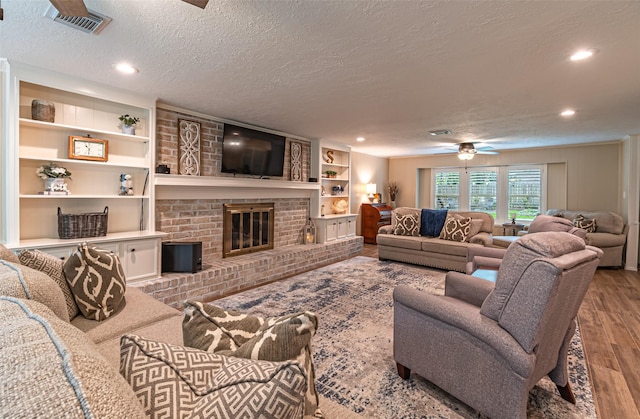 living area featuring recessed lighting, a ceiling fan, a textured ceiling, and wood finished floors