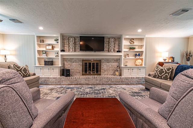 living area with recessed lighting, a textured ceiling, visible vents, and a fireplace