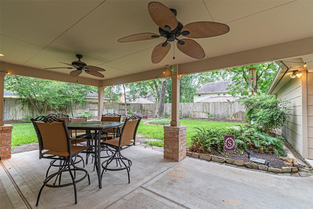 view of patio featuring ceiling fan, a fenced backyard, and outdoor dining space