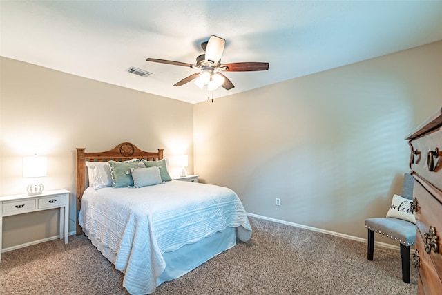 carpeted bedroom featuring baseboards, a ceiling fan, and visible vents