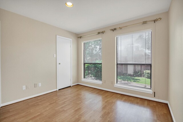 7447 Cambridge St, Houston, TX 77054 - empty room with baseboards, plenty of natural light, and wood finished floors