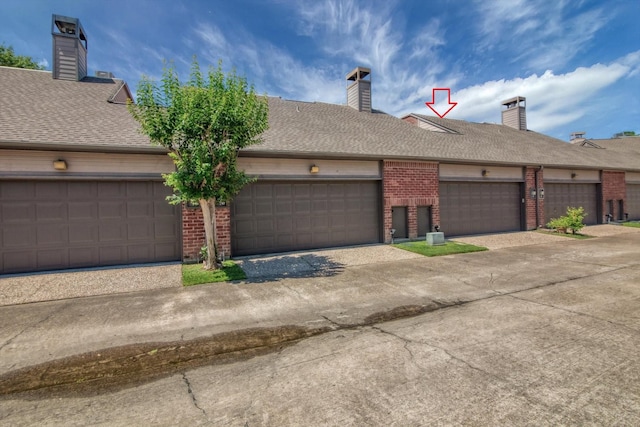 7447 Cambridge St, Houston, TX 77054 - view of front of home with brick siding, a chimney, and roof with shingles