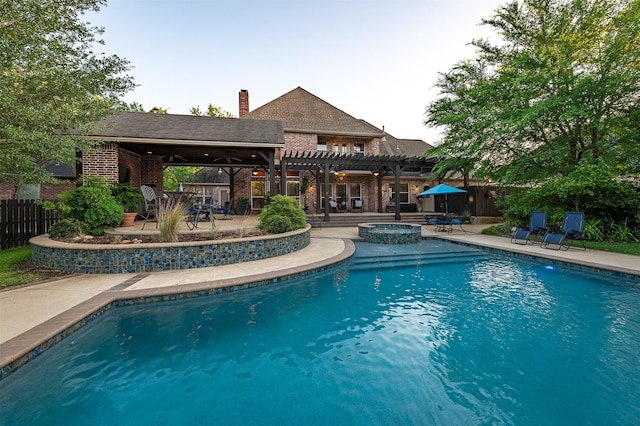 view of swimming pool featuring a patio, fence, a pergola, and a pool with connected hot tub