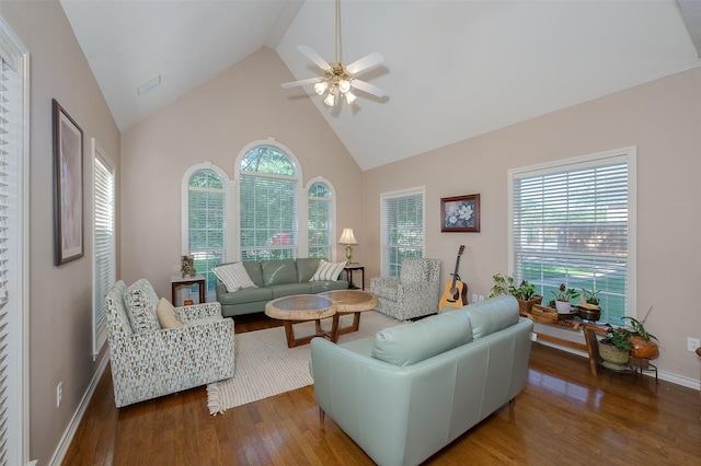 living room with baseboards, high vaulted ceiling, ceiling fan, and wood finished floors