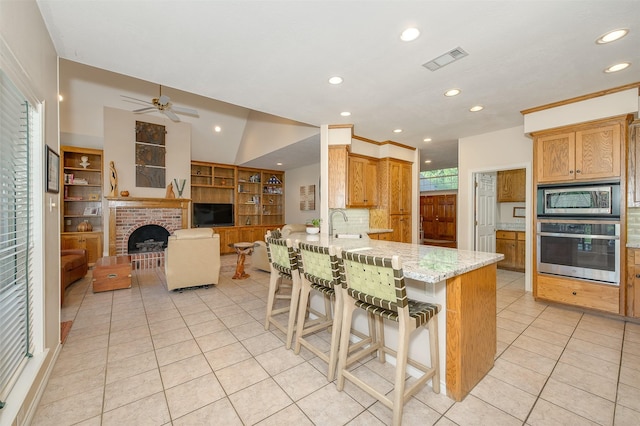 kitchen with visible vents, a peninsula, light tile patterned flooring, recessed lighting, and appliances with stainless steel finishes