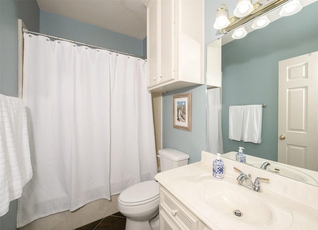 bathroom featuring tile patterned flooring, toilet, and vanity
