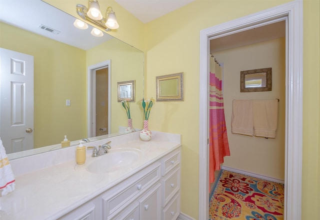 bathroom featuring baseboards, visible vents, and vanity