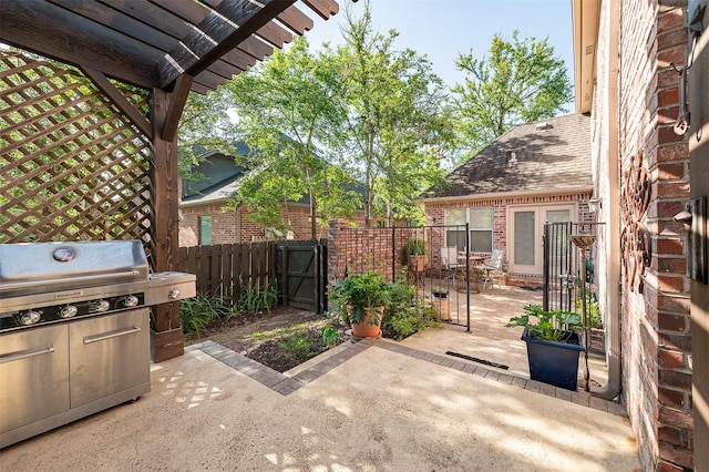 view of patio / terrace with a pergola, fence, a gate, and a grill