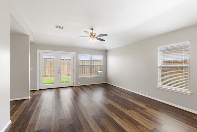 empty room with visible vents, baseboards, and dark wood-style floors