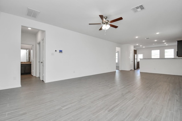 25489 Northpark Spruce Dr, Porter, TX 77365 - unfurnished living room with recessed lighting, ceiling fan, visible vents, and light wood-style floors